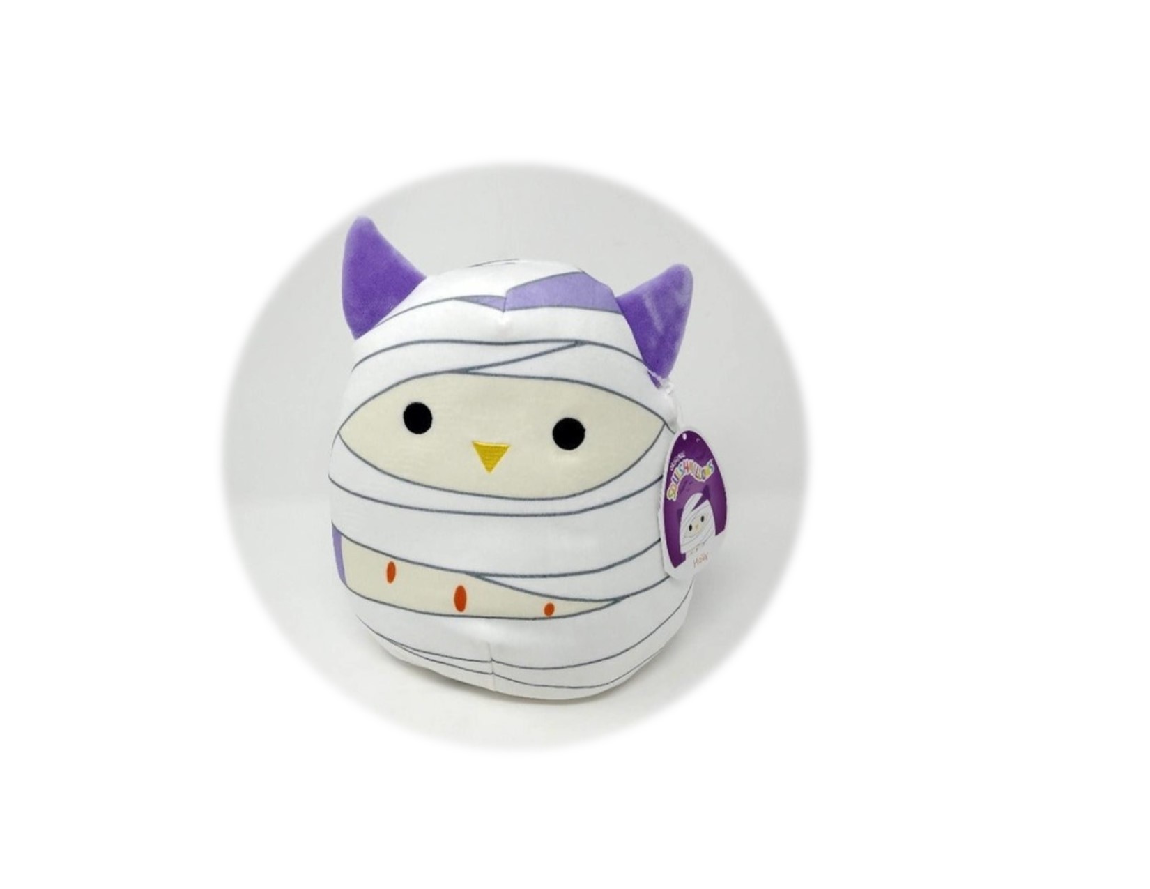 White Squishmallow  bat with purple ears wrapped as a mummy