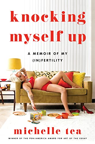 A pregnant white woman laying on a couch with her arm draped across her forehead.