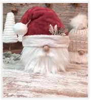 Santa gnome with a silver leaf in his hat. 