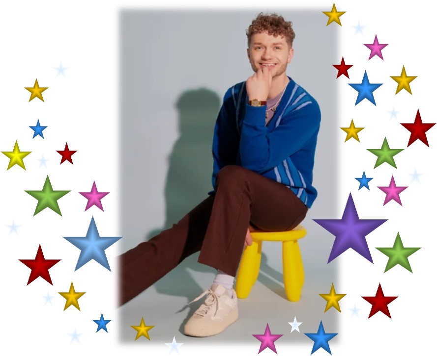 Young man with a blue sweater and brown pants seated on a bright yellow stool surrounded by multicolored stars. 