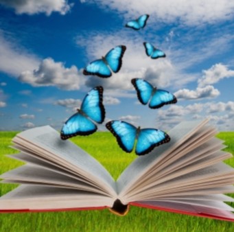 Open book with five blue butterflies flying out. Blue sky with white clouds are in the background. 