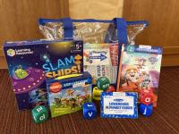 STEAM kit contents (clear vinyl carrying bag, science games and cards, books)