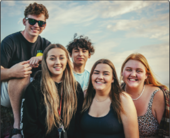Group of five teens posing for a picture
