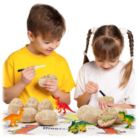 Boy and girl chipping away at a dino egg. 