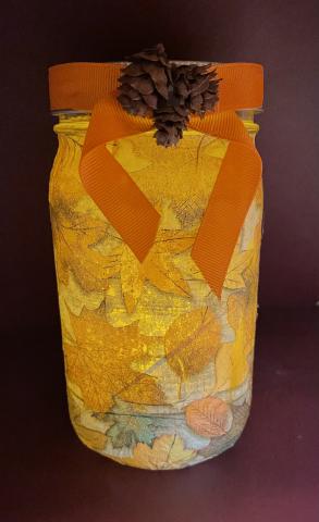 Glass jar with fall leaves. 