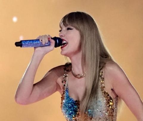 Photo of Taylor Swift singing with a microphone. 