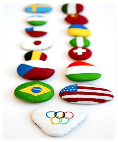 Rocks painted in different flags and the Olympic rings.
