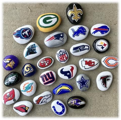 Rocks painted with sports team logos. 