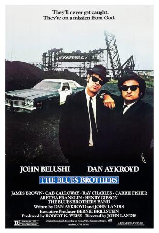 Image of two men in suits with black hats and black suits. "Blues Brothers"