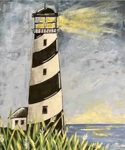 Image of a lighthouse shining over a sea with a grey sky, a white house in the background and green grass in front.