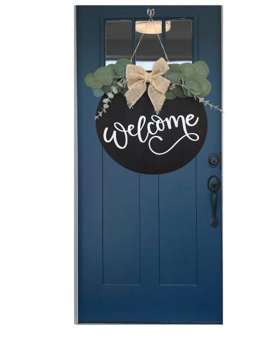 A blue door with a black "Welcome" sign. 
