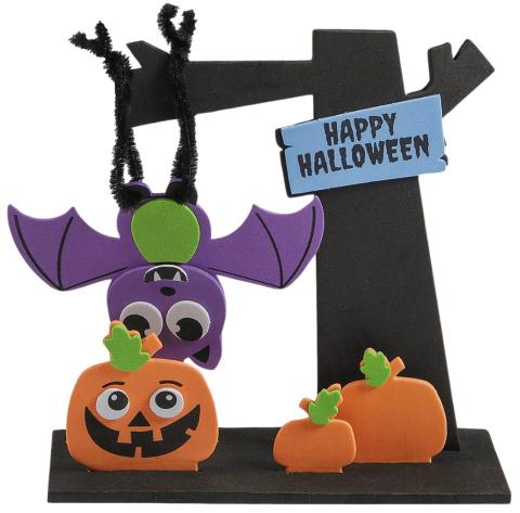 3D foam craft scene with a purple bat hanging upside down from a black tree. On the ground is a Jack O Lantern pumpkin and 2 small pumpkins. A Happy Halloween sign is posted on the tree.