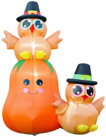 Inflatable pumpkin with a Pilgrim turkey sitting on top and next to it. 