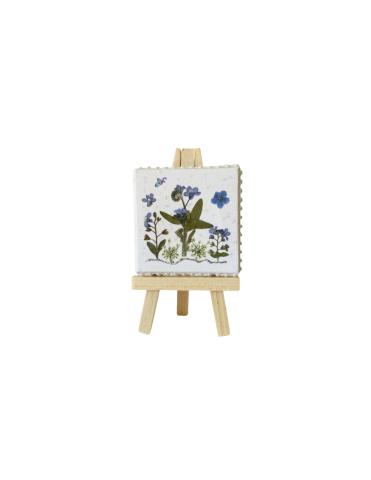 White tile with purple flowers and green leaves on a wooden easel.