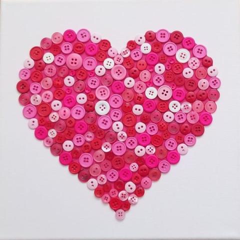 HEART CRAFTED FROM DIFFERENT SHADES OF PINK AND WHITE BUTTONS.
