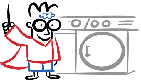 Boy with glasses holding a pen and wearing black glasses, red shirt and cape and blue shorts standing next to a washing machine. 
