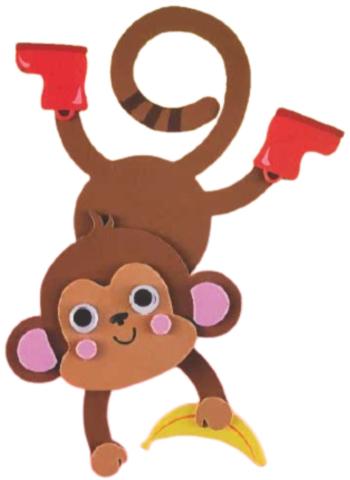 Foam, brown chimpanzee hanging upside down holding a yellow banana and wearing red boots. 