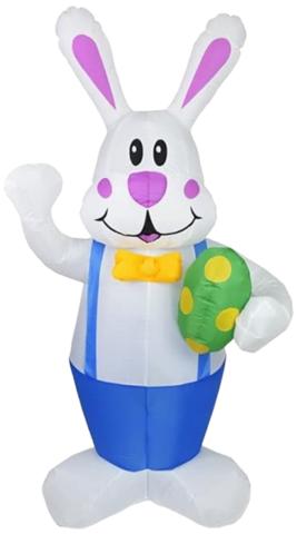 White inflatable bunny standing up holding a green egg with yellow polka-dots. Bunny is wearing blue overalls and a yellow bow tie. 