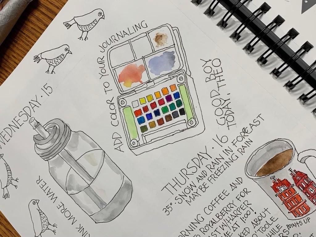 Open journal with hand-drawn illustations of art supplies. 