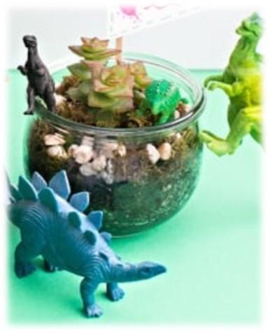 Dinosaurs in a glass terrarium.
