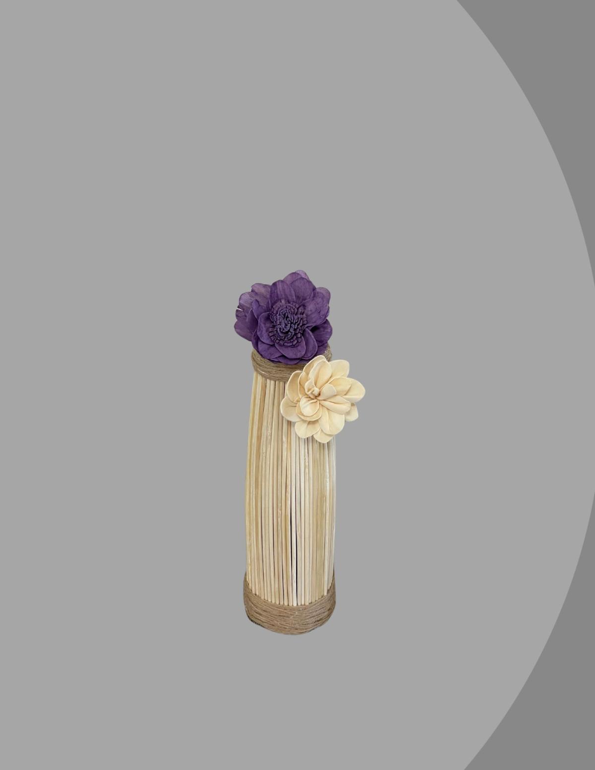 Wood vase with purple and cream colored flowers. 