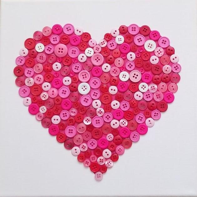 HEART CRAFTED FROM DIFFERENT SHADES OF PINK AND WHITE BUTTONS.