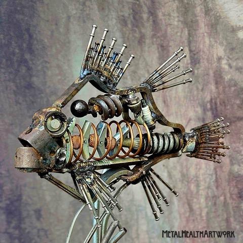 A metal artwork piece in the shape of a fish.